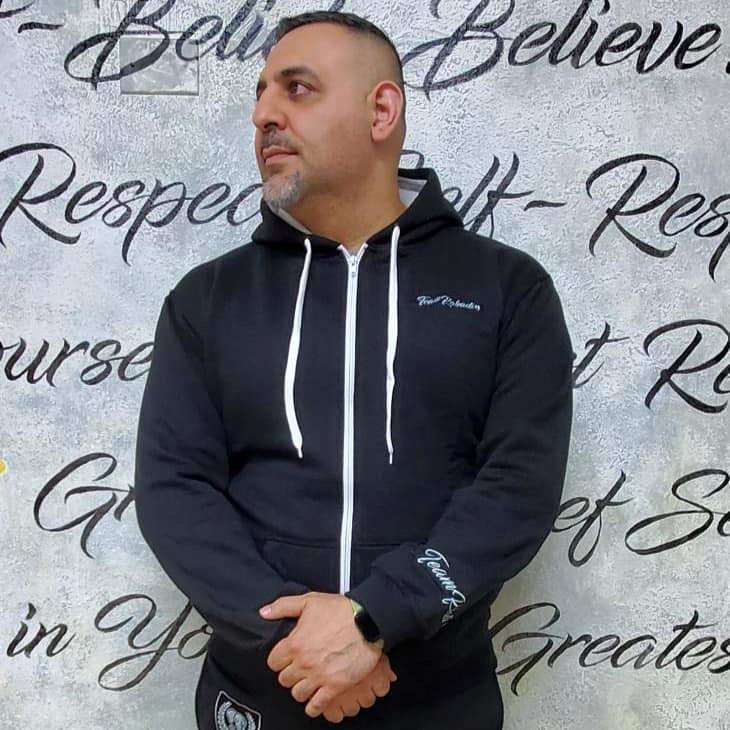 Man in black Team Rabadi zip-up hoodie